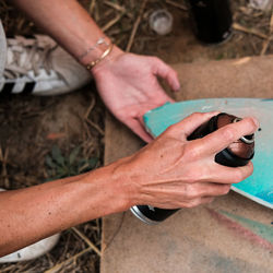 Cropped hand of woman using spray paint