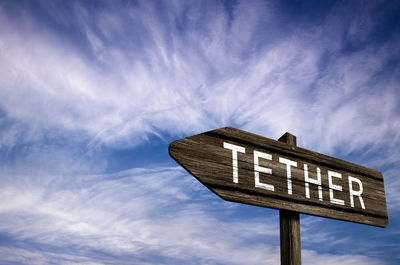 Low angle view of road sign against sky