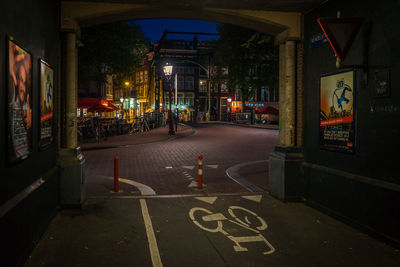 Empty road along built structures