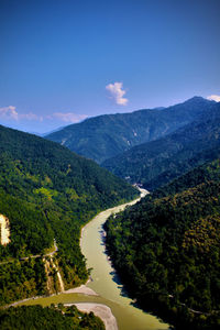 Scenic view of river amidst mountains against sky