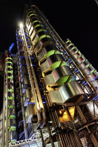 Low angle view of illuminated skyscraper against sky at night