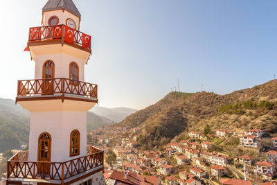 View of buildings in town against clear sky