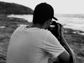 Woman photographing on beach