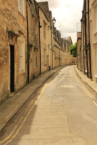 Empty road amidst buildings in town