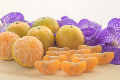 Close-up of fruits with flowers on table