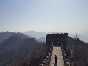 High angle view of silhouette person walking on great wall of china against clear sky