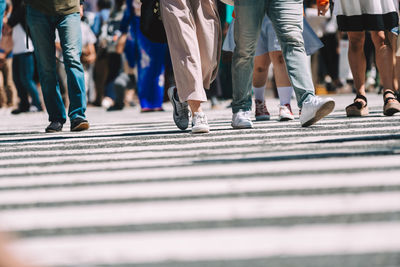 Low section of people walking on street