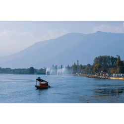 Boat sailing in sea against sky
