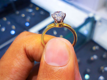 Close-up of person holding wedding rings