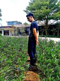Full length of man standing by plants
