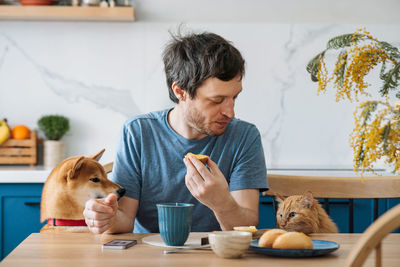 Young man sitting in a cat