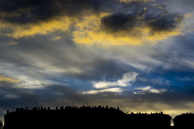 Low angle view of silhouette trees against sky at sunset