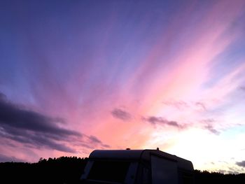 Low angle view of silhouette buildings against dramatic sky