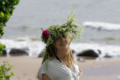 Portrait of woman wearing flowers outdoors