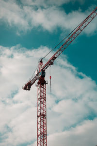 Low angle view of crane against sky
