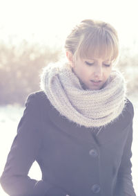 Close-up of woman in warm clothing standing outdoors