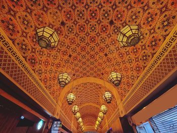 Low angle view of illuminated chandelier in building