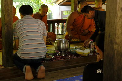 Rear view of people sitting at table