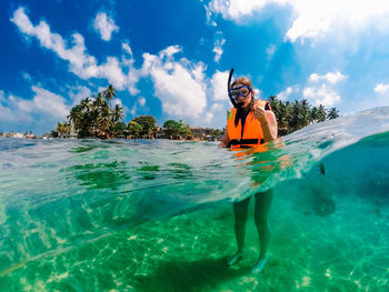 Portrait of woman in sea against sky . dom gopro case . underwater in srilanka