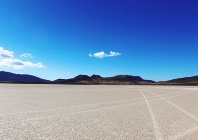 Scenic view of desert against blue sky