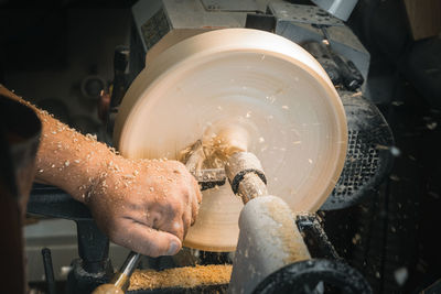 Midsection of person working in cooking pan