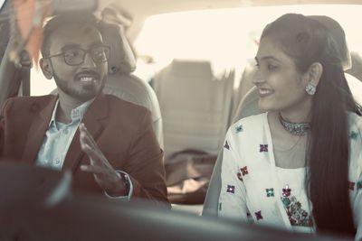 Portrait of a smiling young man sitting in car