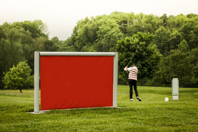 Man playing with ball on golf course