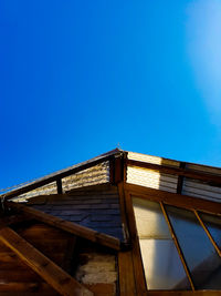 Low angle view of building against clear blue sky