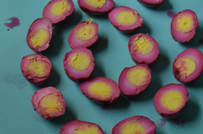 High angle view of pickled eggs on turquoise table