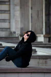 Young woman sitting on stairs