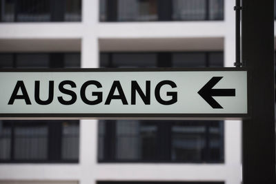 Black and white exit - ausgang - sign with arrow pointing to the left