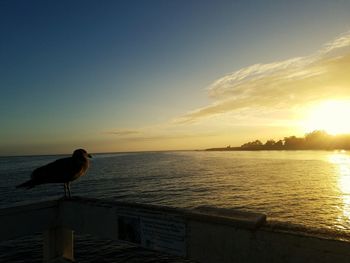 Scenic view of sea against sky at sunset