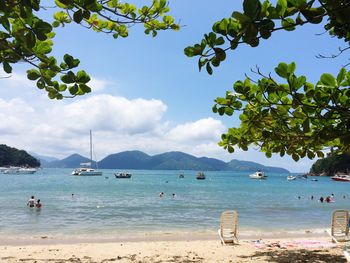 Scenic view of beach and mountains against sky