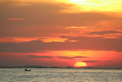 Scenic view of sea against orange sky