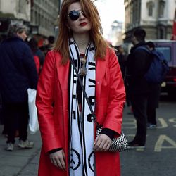 Young woman wearing sunglasses standing on street in city
