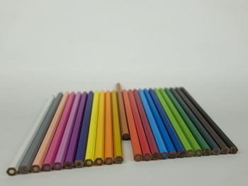 Close-up of colored pencils against white background