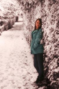 Woman standing on snow covered land