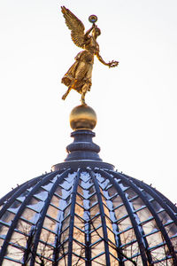 Low angle view of statue against cloudy sky