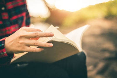 Close-up of hand holding book