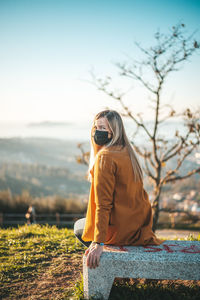 Woman wearing sunglasses on field against sky