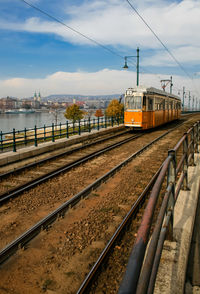 Train on railroad tracks against sky