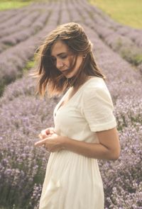 Young woman standing on lavender field