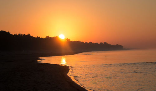 Scenic view of lake ontario against clear sky during sunset