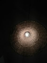 Low angle view of illuminated pendant light in darkroom