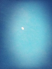 Low angle view of moon against blue sky