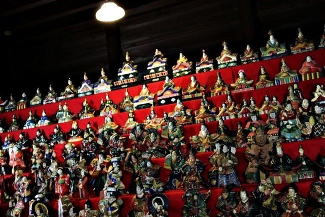 red, lantern, illuminated, hanging, built structure, architecture, lighting equipment, cultures, decoration, in a row, indoors, tradition, religion, chinese lantern, market, large group of objects, low angle view, abundance, night, culture