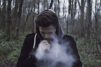 Man smoking in forest