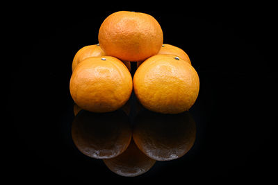 Close-up of oranges against black background