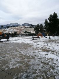 Scenic view of frozen river against sky during winter