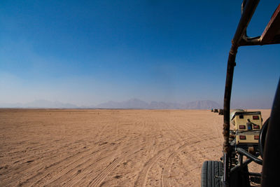 Scenic view of desert against blue sky